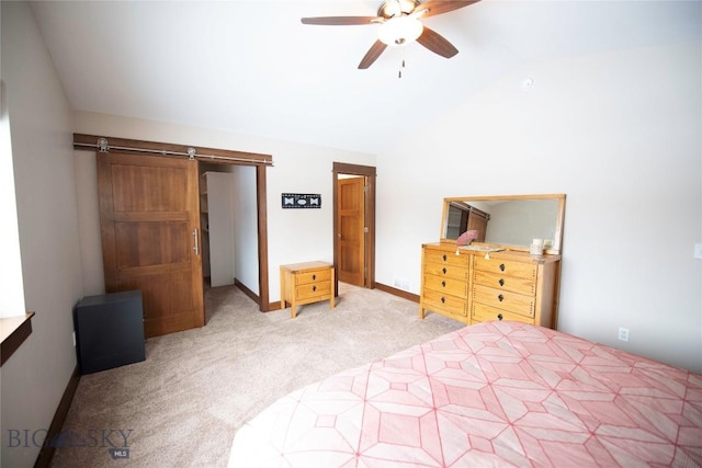 bedroom featuring a barn door, baseboards, a ceiling fan, light colored carpet, and lofted ceiling