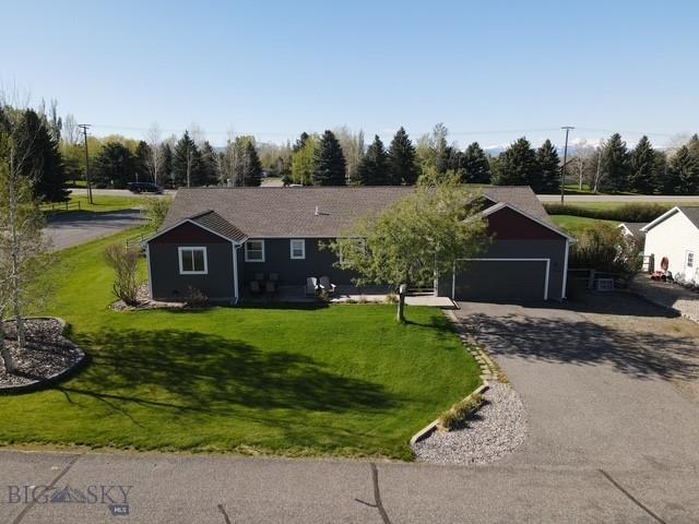 480 Prospector Trl, Bozeman, MT 59718 - ranch-style house with driveway, a front lawn, and an attached garage