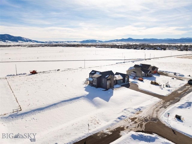 snowy aerial view with a mountain view