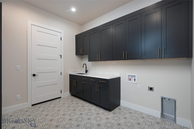 laundry room featuring hookup for a washing machine, a sink, baseboards, cabinet space, and electric dryer hookup