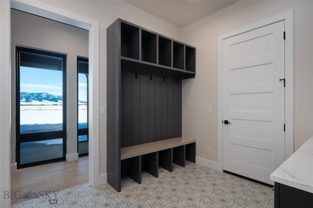 mudroom with a mountain view and baseboards