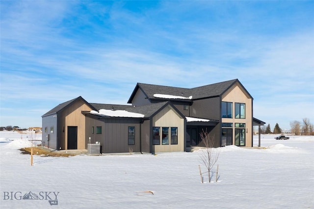 snow covered property with cooling unit