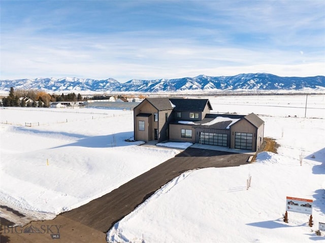 view of front of house with a garage, driveway, and a mountain view