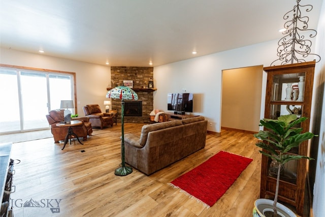 living room with a fireplace, wood finished floors, and recessed lighting