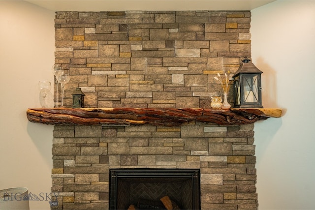 interior details with a stone fireplace