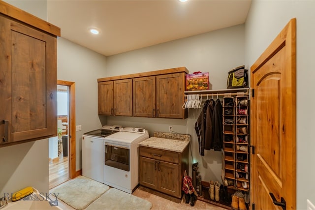 laundry area featuring independent washer and dryer and cabinet space