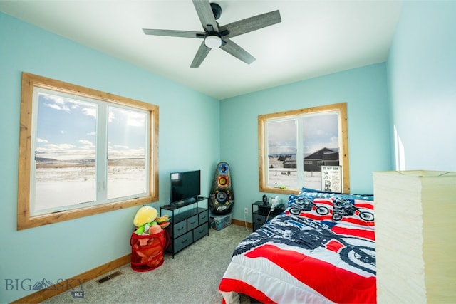 bedroom featuring carpet floors, a ceiling fan, visible vents, and baseboards