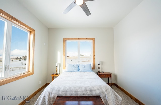 carpeted bedroom with baseboards and a ceiling fan