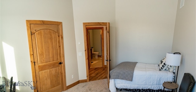 carpeted bedroom featuring baseboards