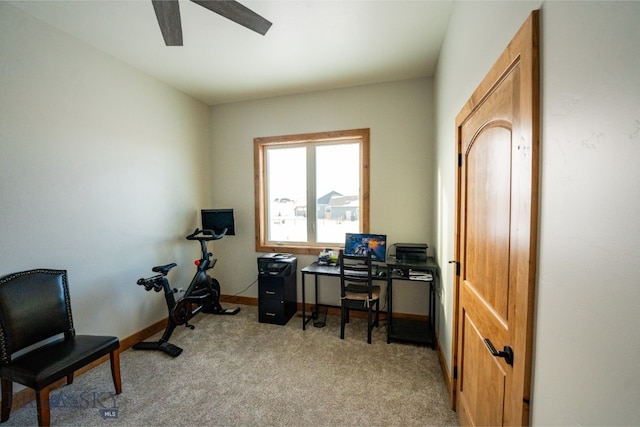 carpeted home office featuring ceiling fan and baseboards