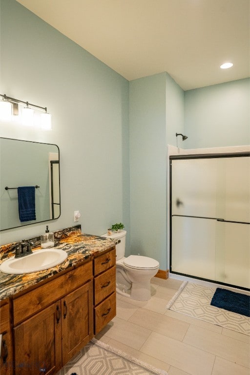 bathroom with toilet, recessed lighting, walk in shower, and vanity