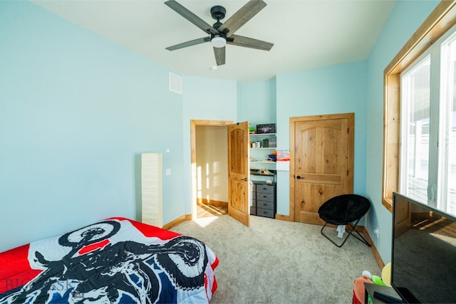 carpeted bedroom with visible vents, ceiling fan, and baseboards