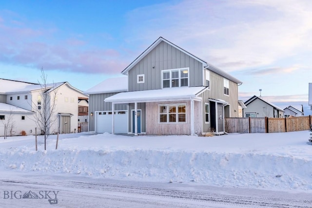 modern farmhouse featuring board and batten siding and fence