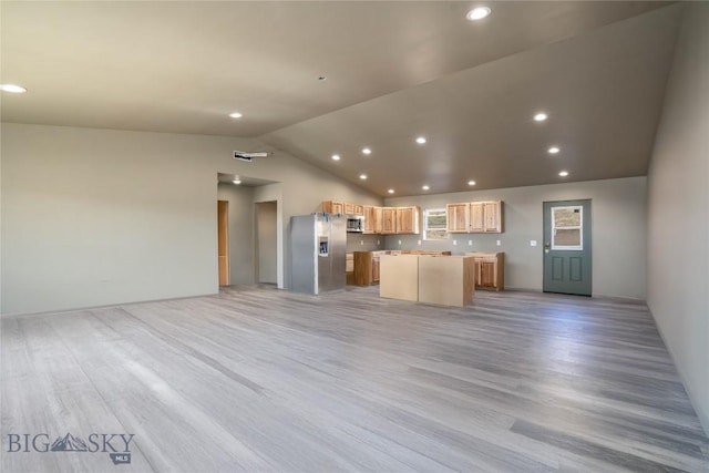 unfurnished living room with light wood-style flooring, vaulted ceiling, and recessed lighting