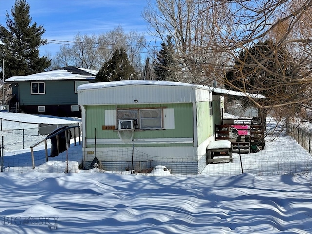 snow covered structure featuring fence