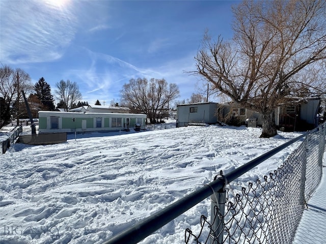 yard covered in snow featuring an outdoor structure