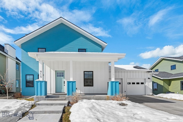 view of front facade featuring an attached garage, driveway, and board and batten siding