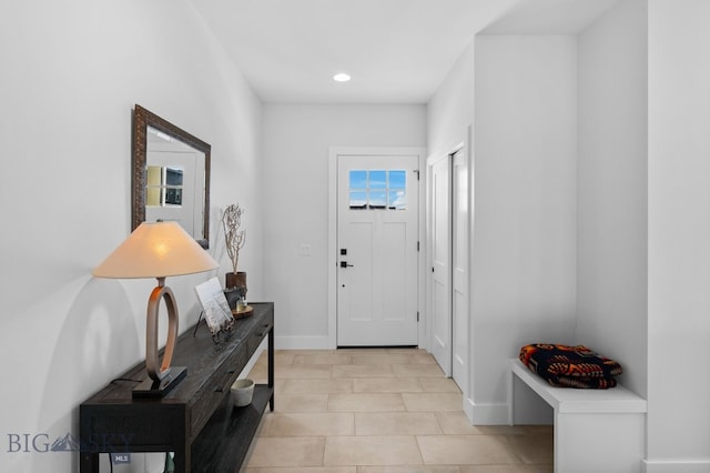 foyer with light tile patterned floors, baseboards, and recessed lighting