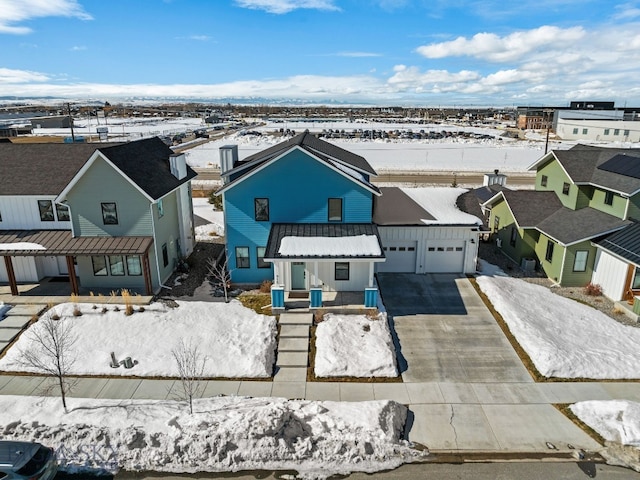 snowy aerial view with a residential view