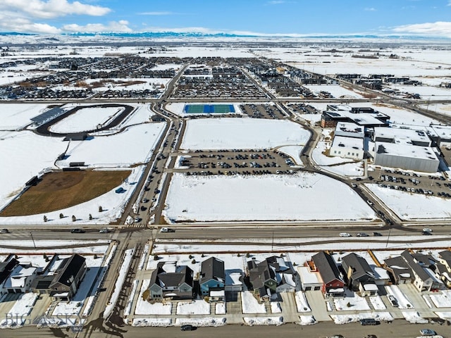 snowy aerial view with a residential view