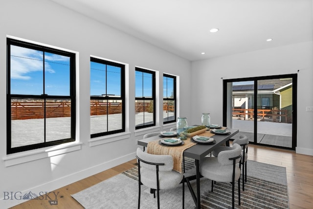 dining space featuring recessed lighting, baseboards, and wood finished floors