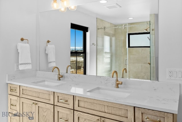 bathroom with double vanity, plenty of natural light, and a sink