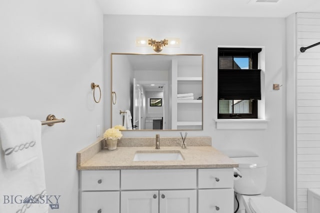 full bath with visible vents, vanity, and toilet