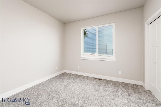 unfurnished bedroom with a closet, carpet flooring, visible vents, and baseboards