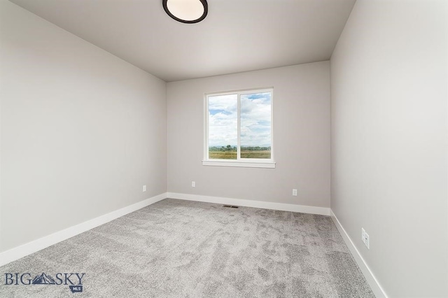 carpeted empty room with visible vents and baseboards