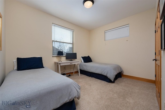 carpeted bedroom featuring baseboards