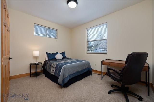 bedroom featuring carpet flooring and baseboards