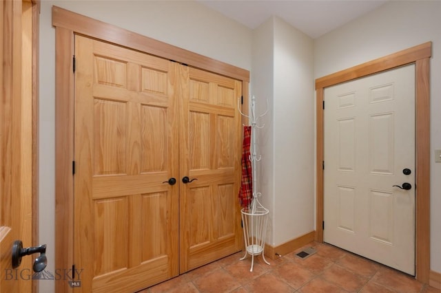 entryway with light tile patterned floors, visible vents, and baseboards