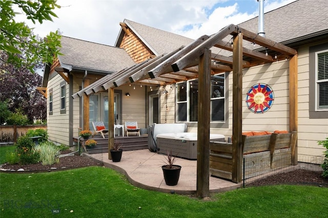 back of property with a patio area, a yard, a hot tub, and roof with shingles