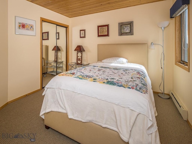 bedroom with wooden ceiling, a baseboard heating unit, carpet floors, baseboards, and a closet