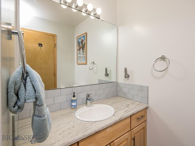 bathroom featuring vanity and decorative backsplash