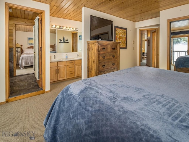 carpeted bedroom with wood ceiling, connected bathroom, and a sink