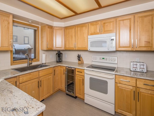 kitchen featuring beverage cooler, white appliances, a sink, and light stone countertops