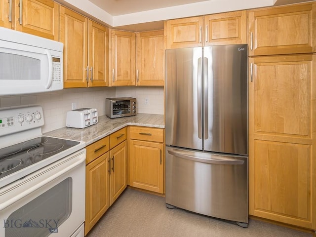 kitchen with white appliances, a toaster, light stone counters, and backsplash