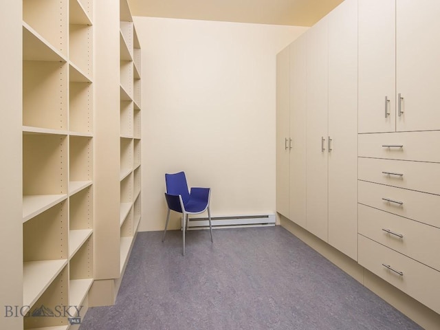 spacious closet with a baseboard heating unit