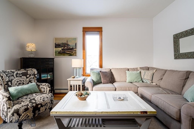 living room with a baseboard heating unit and wood finished floors