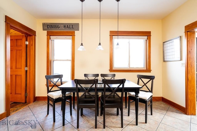 dining space with light tile patterned floors and baseboards