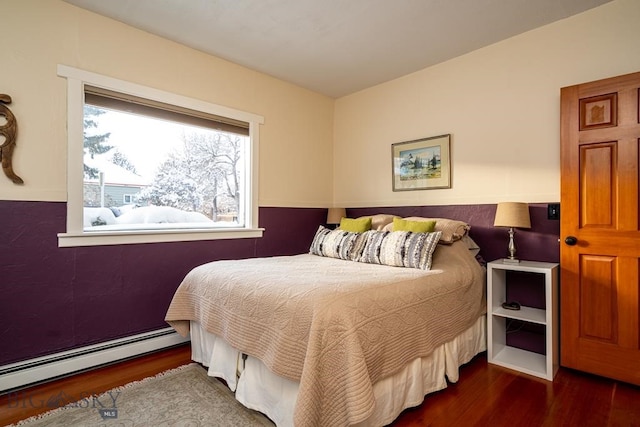 bedroom featuring a baseboard radiator and wood finished floors