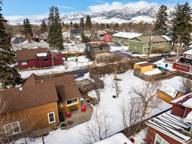 snowy aerial view with a residential view and a mountain view