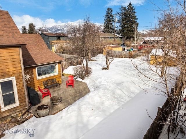 snowy yard featuring fence and a fire pit