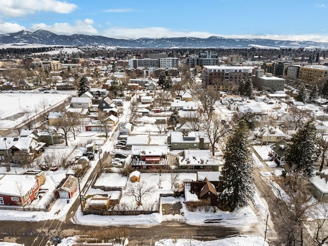 snowy aerial view featuring a mountain view