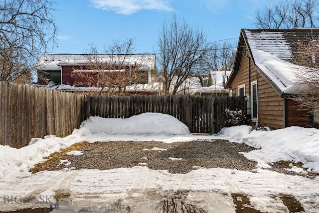 snowy yard with fence