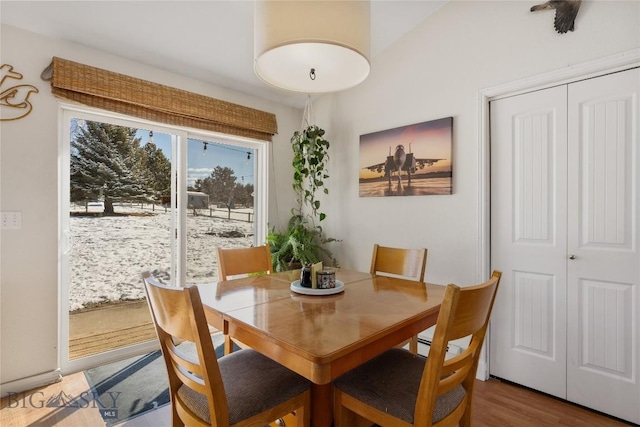 dining space with wood finished floors