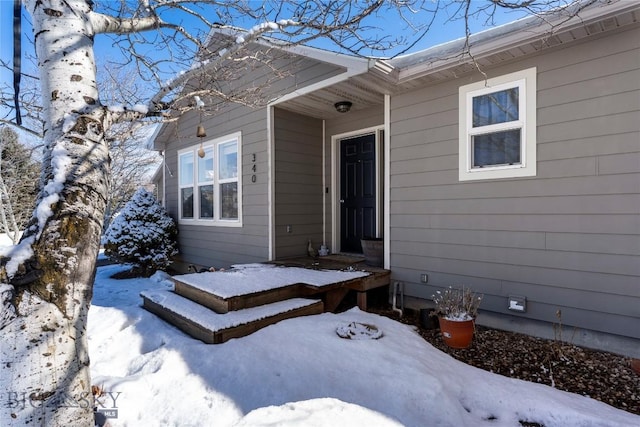 view of snow covered property entrance