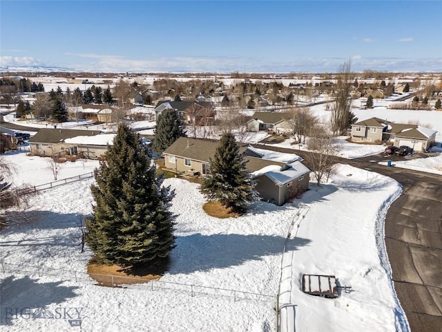 snowy aerial view with a residential view