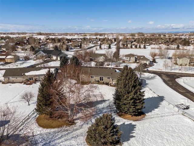 snowy aerial view with a residential view